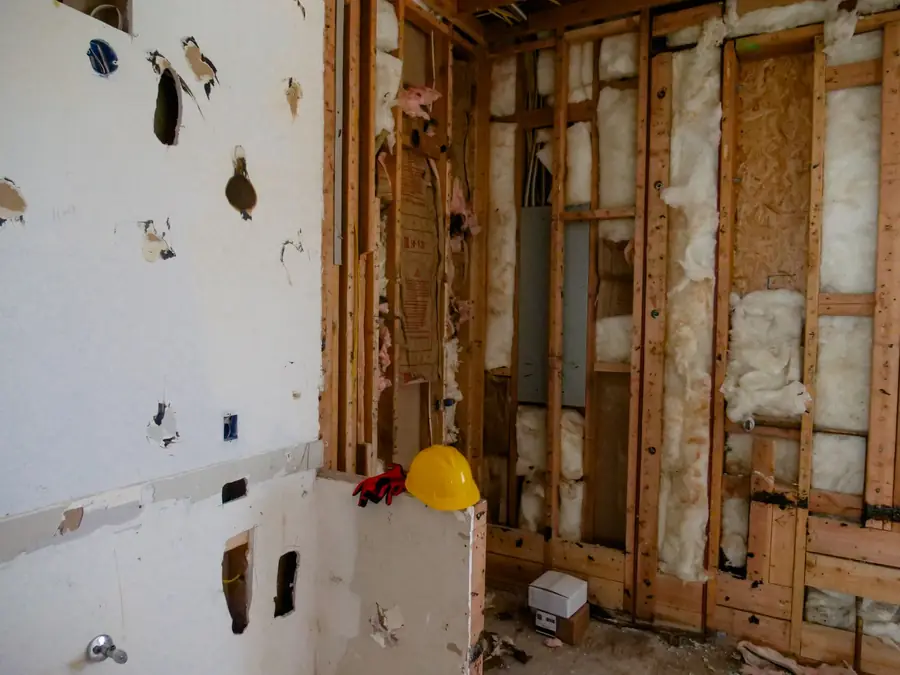 Room with drywall cut away to the studs after water damage