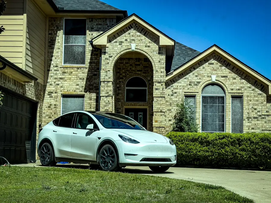 Brick and stone Texas home with a car in the driveway